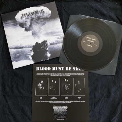 Disco de vinil preto com capa em preto e branco mostrando explosão nuclear, texto Zyklon B e encarte com texto e imagens