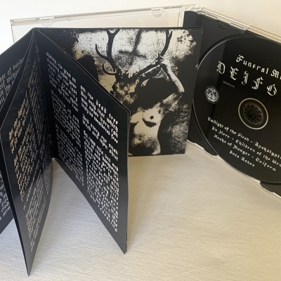 CD Funeral Mist Devilry num estojo aberto com livreto com texto manuscrito