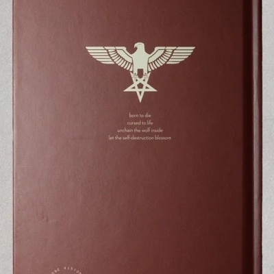 Caderno ou livro com capa dura castanha com símbolo dourado e texto em inglês