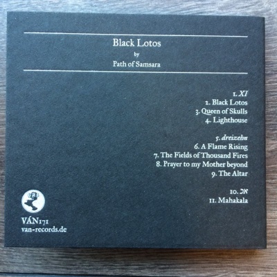 Capa traseira de álbum Black Lotos com lista de músicas e logo da editora sobre madeira