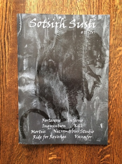 Livro Sotsirh Susii com capa preta e texto branco sobre madeira