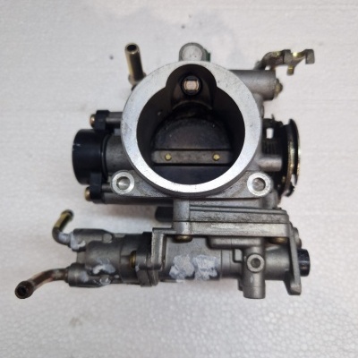 Corpo do acelerador metálico usado sobre fundo branco