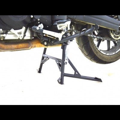 Suporte central preto para motocicleta com mola visível, moto em fundo claro