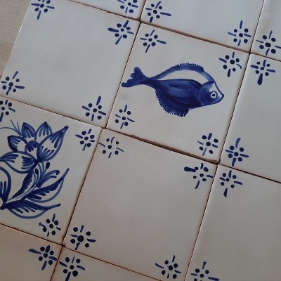 Azulejos cerâmicos decorativos com motivos em azul, peixe e flor