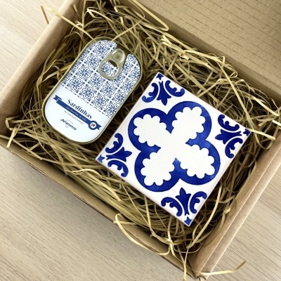 Gift box with tin can labeled Sardinhas in blue patterns and blue white decorative ceramic tile