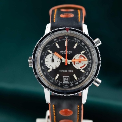 Relógio de pulso Breitling com mostrador preto e pulseira de couro laranja e preto
