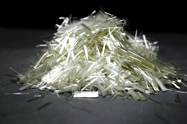 Montanha de fibras brancas e finas sobre superfície cinzenta e fundo escuro