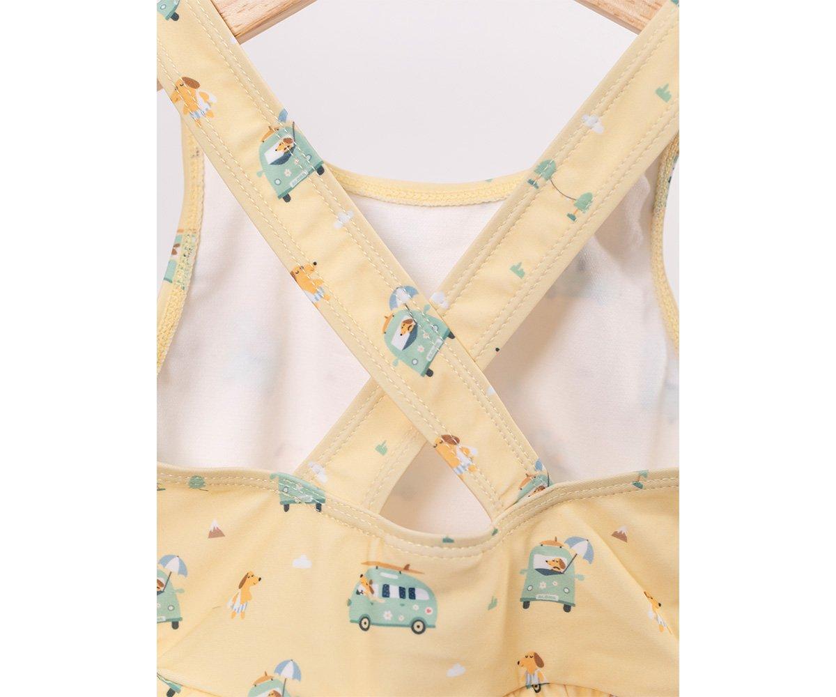 Top amarelo claro com padrão de autocarros, cães e corações