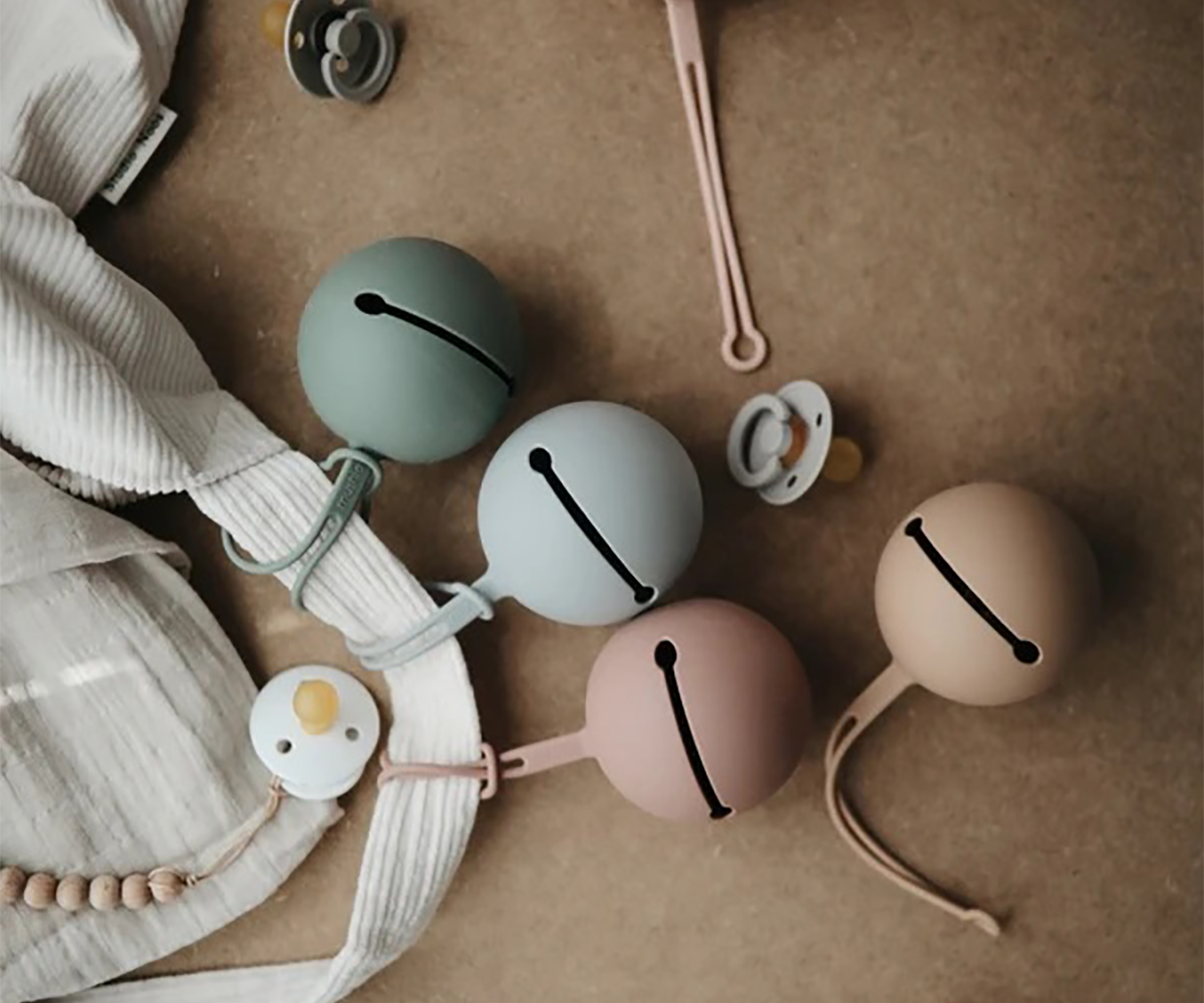 Quatro sinos de silicone coloridos com chupetas e tecido listrado