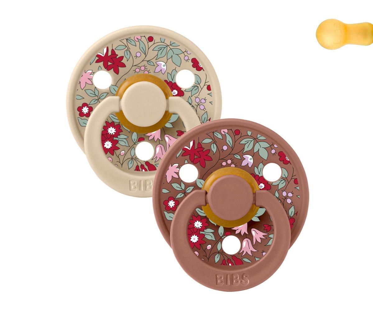 Dois biberões BIBS beige e castanho com flores coloridas e orifícios circulares em fundo branco
