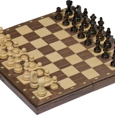 Tabuleiro de xadrez em madeira com peças claras e escuras em posição inicial.