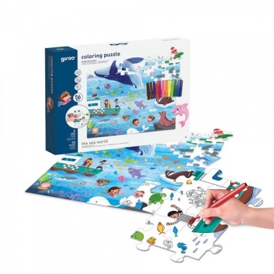 Puzzle para colorir com temática marinha, mão colorindo peça do puzzle e canetas coloridas junto da caixa.
