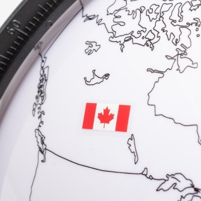 Globo terrestre com contornos de continentes e bandeira do Canadá colada