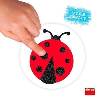 Ícone de joaninha tátil vermelho e preto com mão tocando e texto 'TACTILE SURFACE'