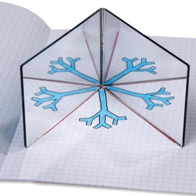 Caderno com páginas quadriculadas e espelho triangular refletindo floco de neve azul