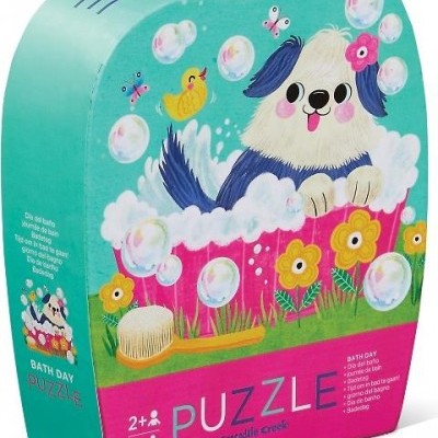 Caixa de puzzle infantil com cão numa banheira e bolhas de sabão, cores azul, rosa, amarelo e verde