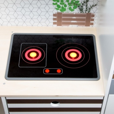 Placa de indução preta com duas zonas de aquecimento numa bancada de madeira