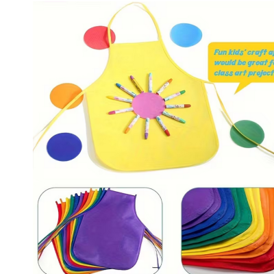 Avental infantil amarelo com decoração colorida e aventais em várias cores empilhados.