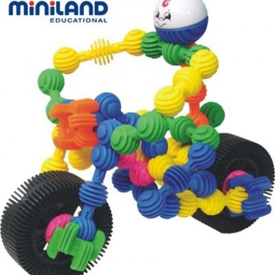 Brinquedo construção plástico colorido em forma de motocicleta com figura sorridente Miniland