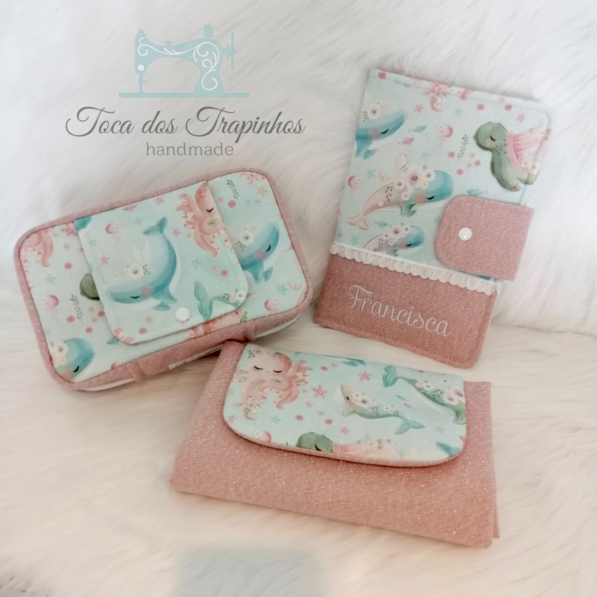Acessórios de tecido cor-de-rosa com padrão de sereias e nome bordado Francesca.