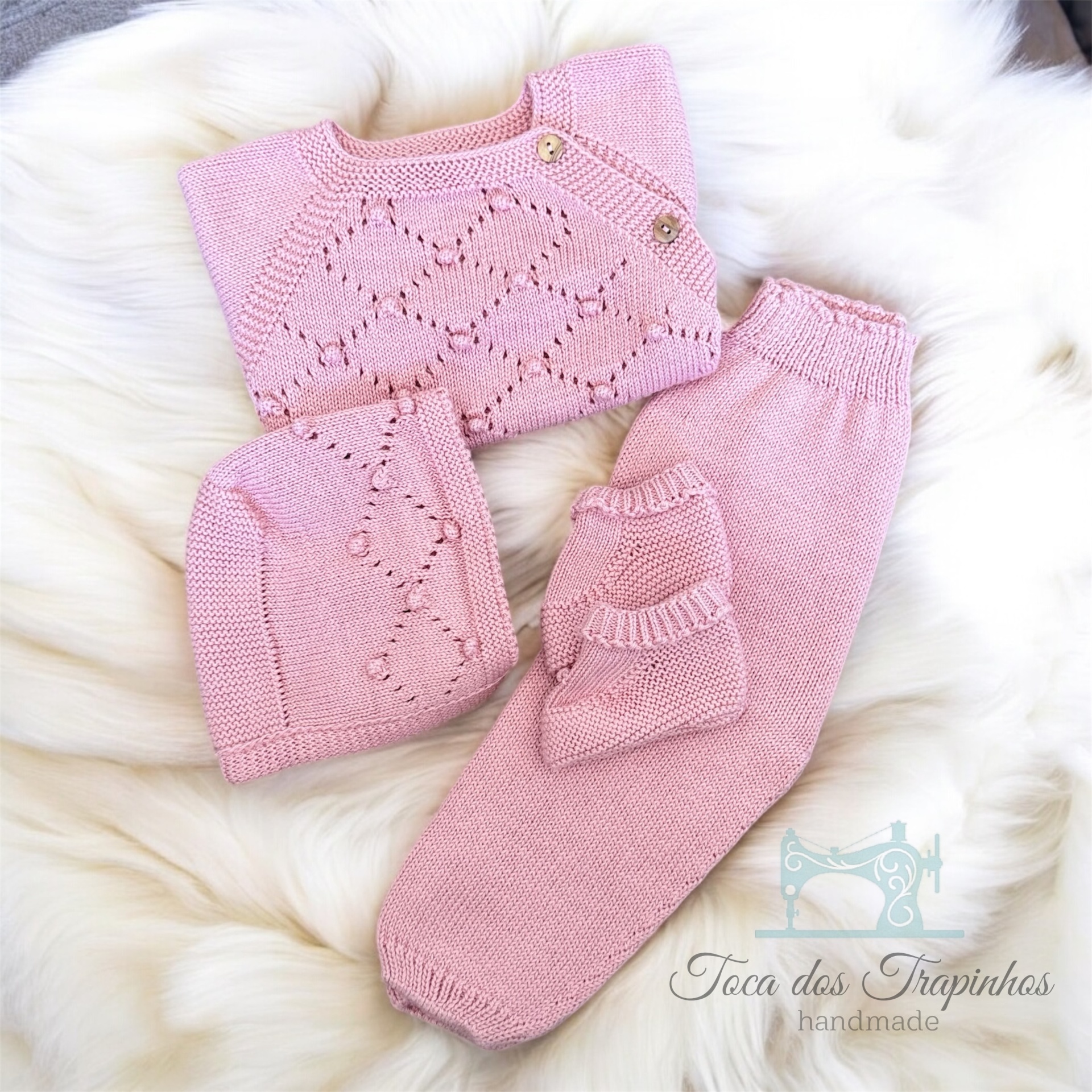 Conjunto de roupa de bebé cor-de-rosa em tricô com camisola, calças, gorro e luvas