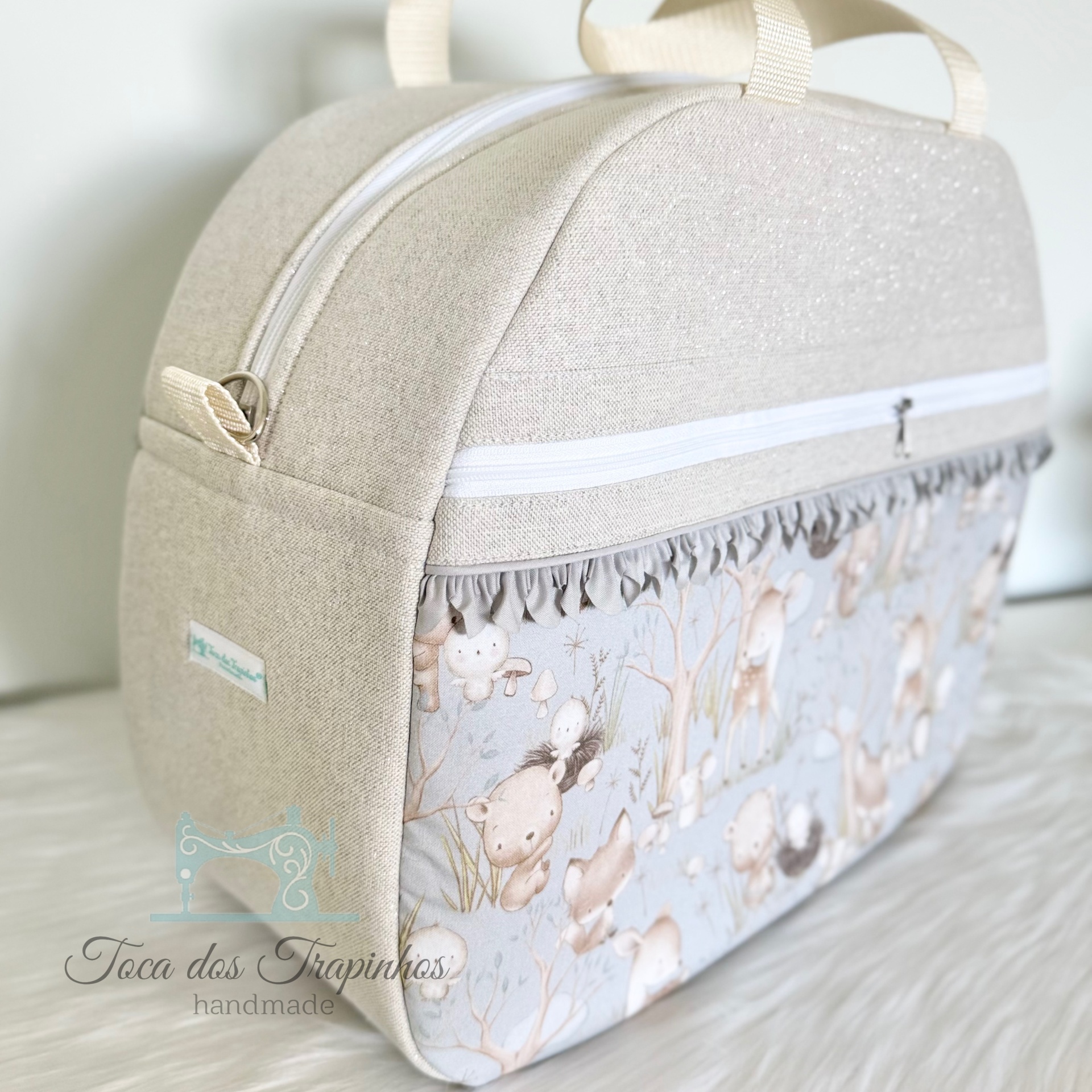 Mala para bebé bege com padrão de animais e fecho branco