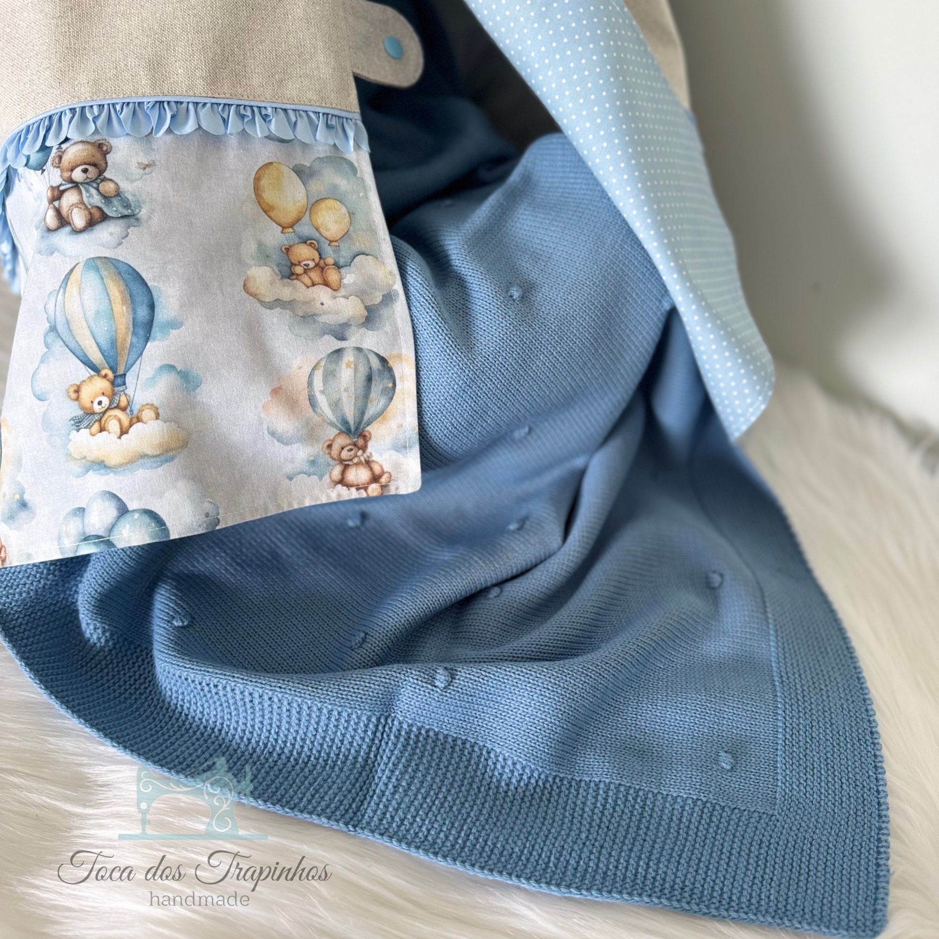 Cobertor azul de malha com tecido estampado de ursinhos em balões e nuvens