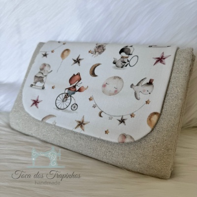 Bolsa de tecido castanho claro com aba estampada infantil com animais e estrelas