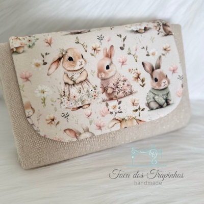 Carteira de tecido com padrão de coelhinhos e flores em tons suaves