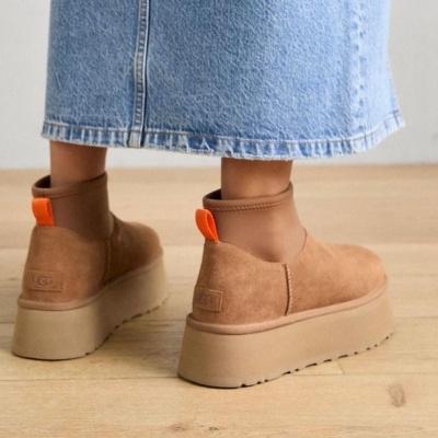 Botas de plataforma UGG castanhas com sola grossa bege e puxador laranja