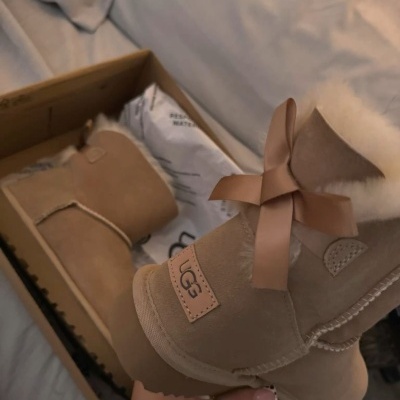 Botas castanhas UGG em camurça com laço e interior de pelo
