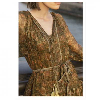 Vestido feminino verde, castanho e dourado com cordões e cinto em ambiente exterior