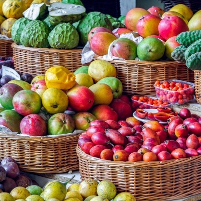 Cestos de vime com várias frutas coloridas em feira ao ar livre