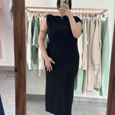 Vestido preto comprido com ombros estruturados em loja de roupa