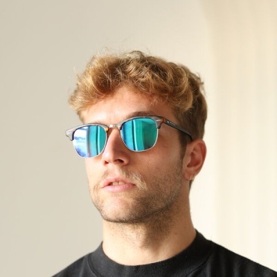 Óculos de sol espelhados azuis com armação preta usados por homem com camiseta preta