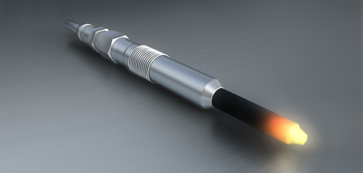 Objeto metálico cilíndrico com luz na extremidade sobre superfície cinza