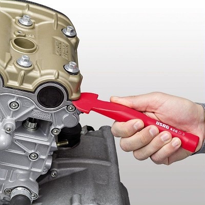 Ferramenta vermelha USAG 429 D-3 usada em motor metálico cinza e dourado