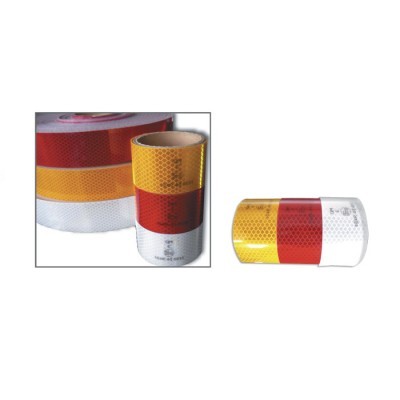 Rolos de fita refletora amarela, vermelha e branca com padrão hexagonal