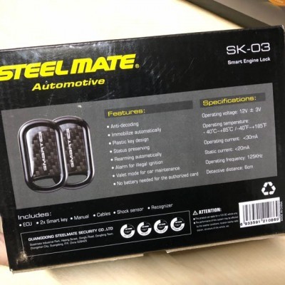 Embalagem preta do Steel Mate SK-03 com texto e imagem do dispositivo