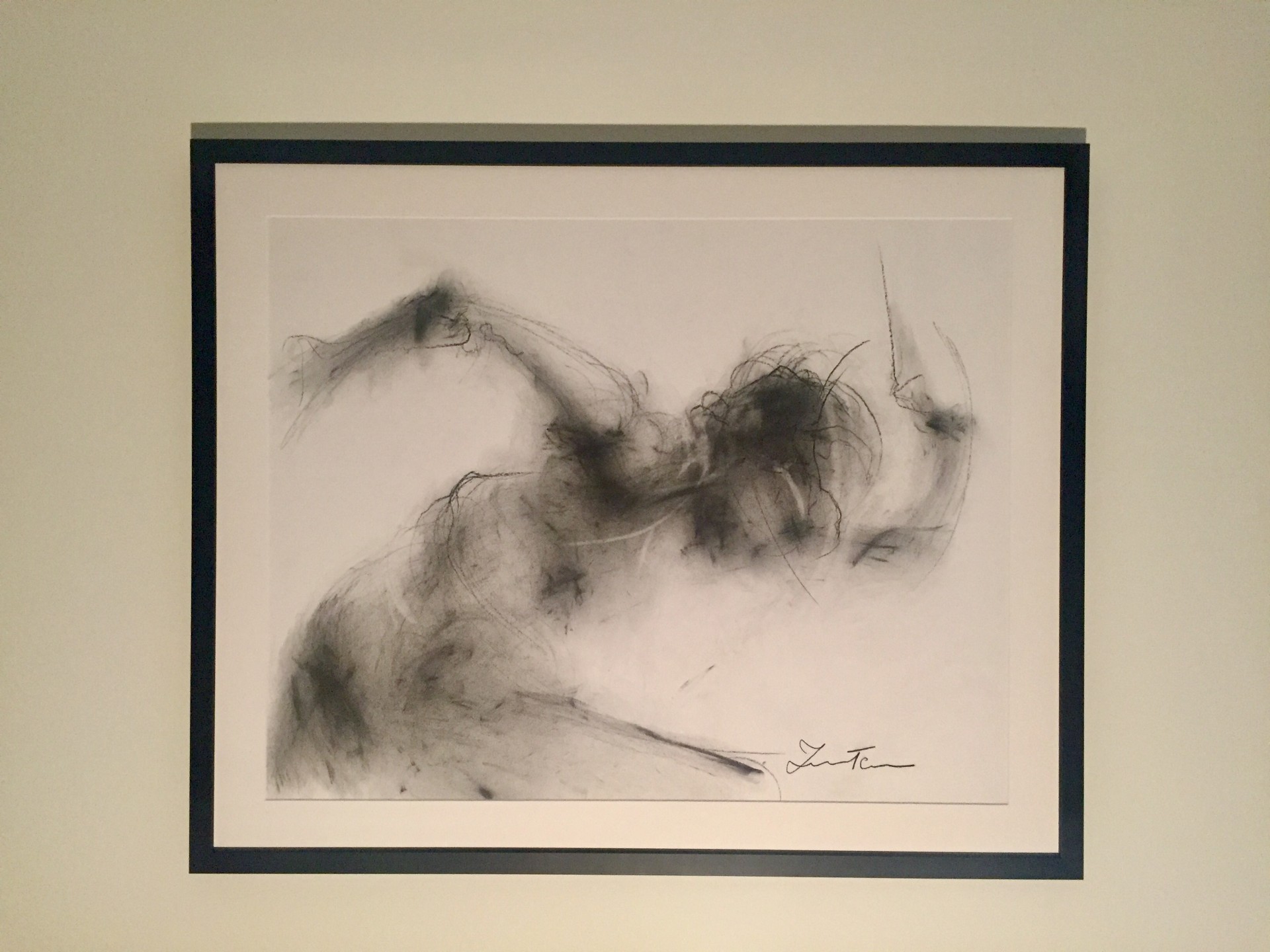 quadro abstrato em moldura preta com desenho cinza de figura humana em movimento