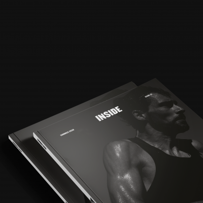 Revistas com capas em preto e branco, homem musculado suado na capa principal, texto 'INSIDE'.