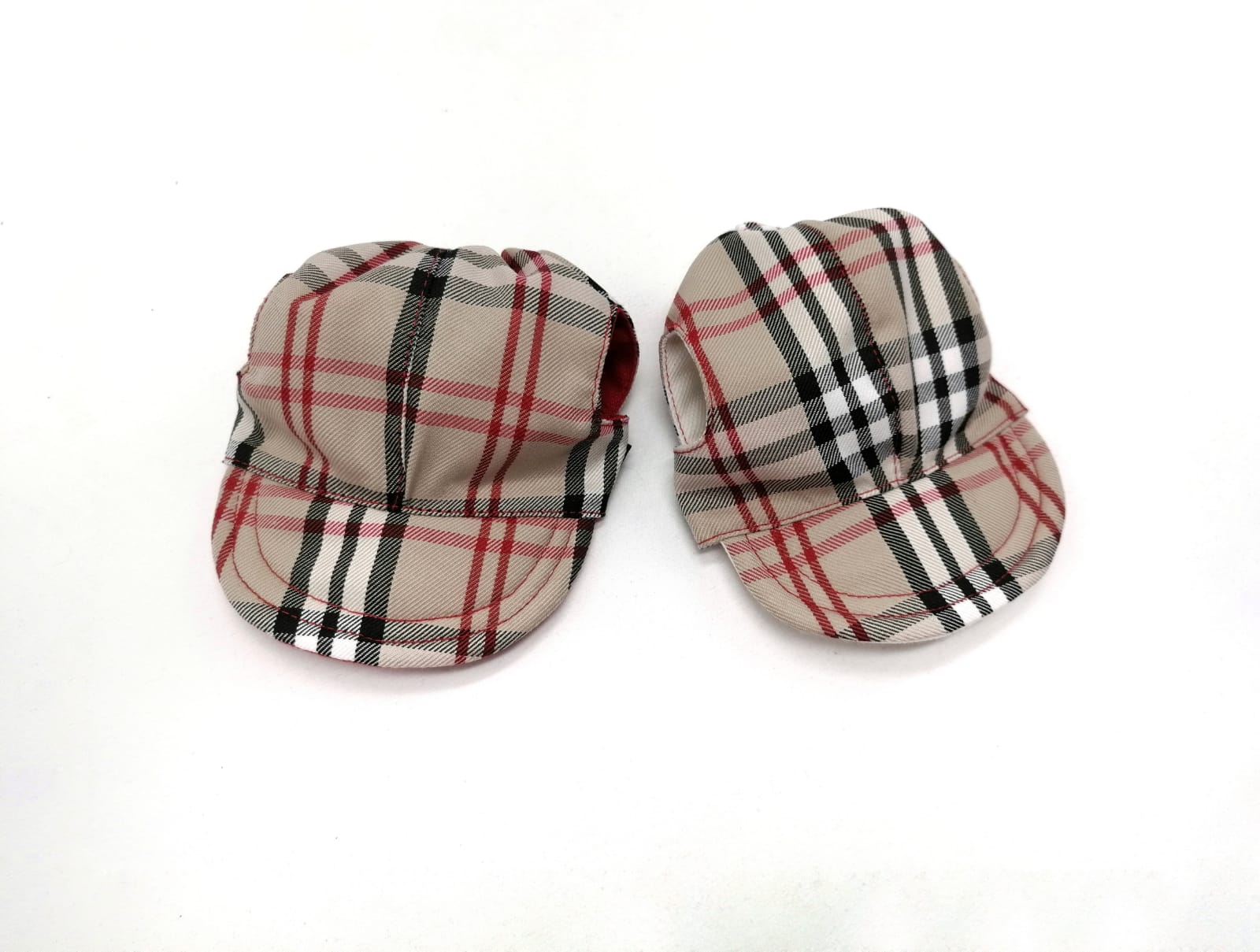 Dois bonés xadrez bege com abas curtas sobre fundo branco