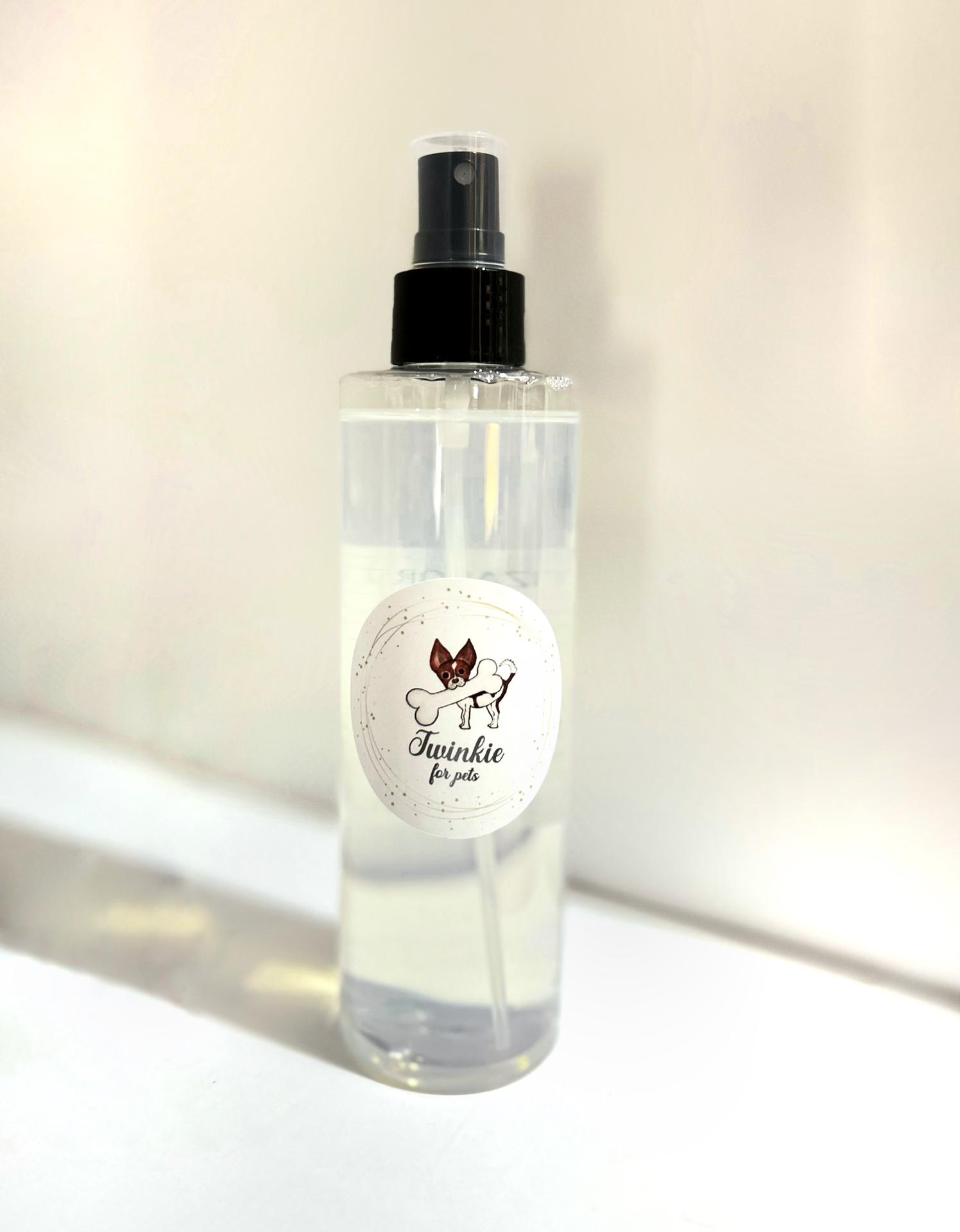 Frasco transparente com pulverizador preto e etiqueta branca com desenho de cão