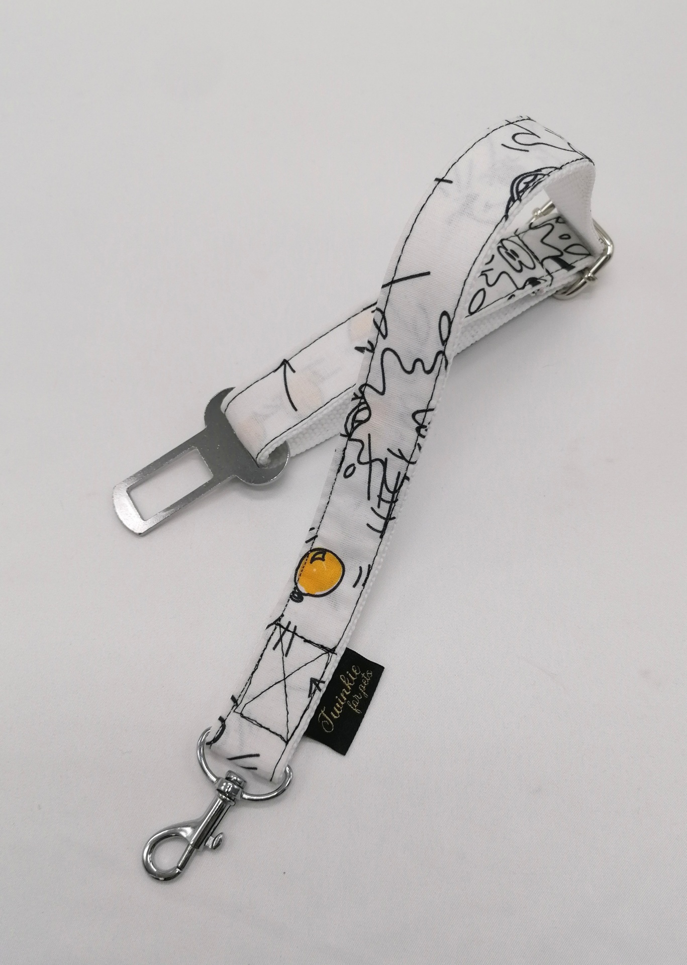 Correia branca com padrão preto e amarelo, gancho metálico e etiqueta preta 'La Festa'