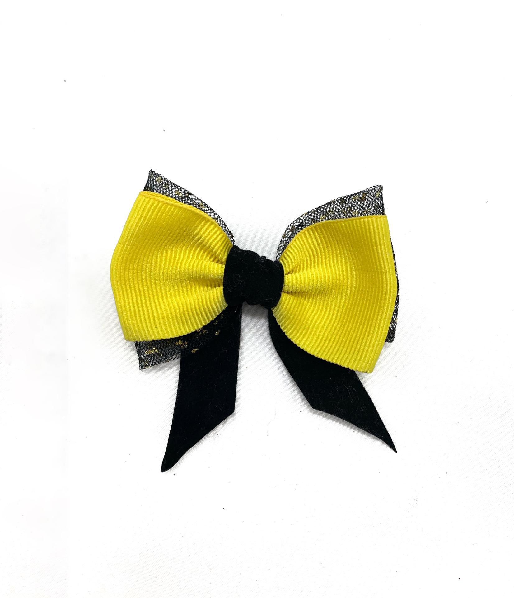 Laço decorativo amarelo e preto sobre fundo branco.