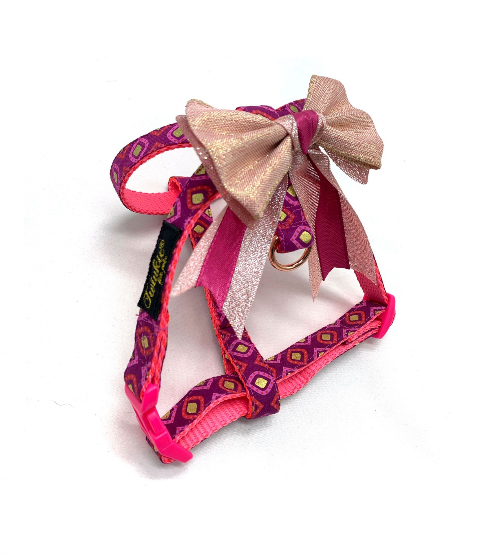 Arnês para animais cor-de-rosa com laço dourado e padrão geométrico