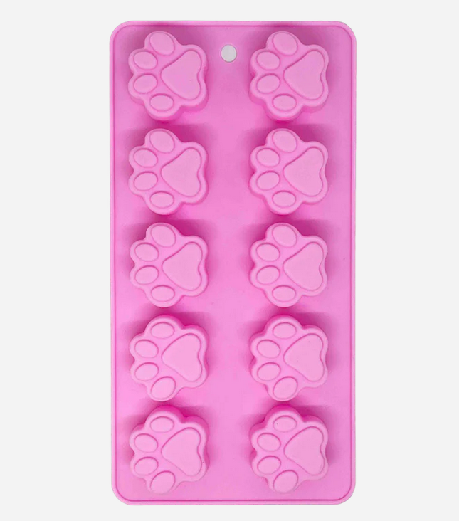 Forma de silicone cor-de-rosa com cavidades em forma de pata de animal