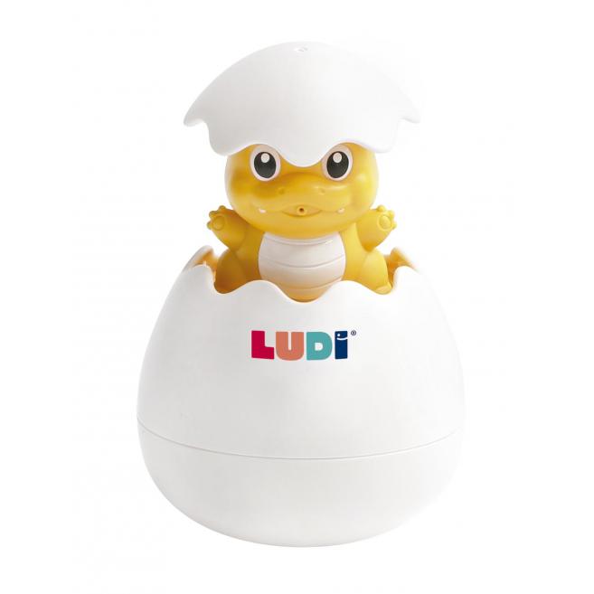Boneco de dinossauro amarelo saindo de um ovo branco partido com texto LUDI