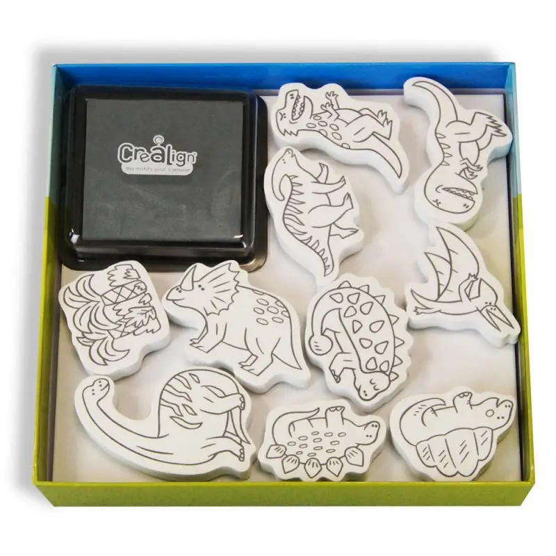 Carimbos de dinossauros em madeira com almofada preta na caixa aberta