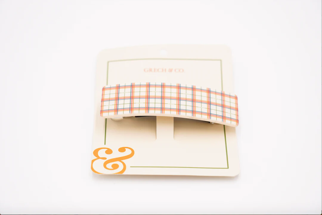 Presilha de cabelo xadrez em embalagem branca com símbolo &